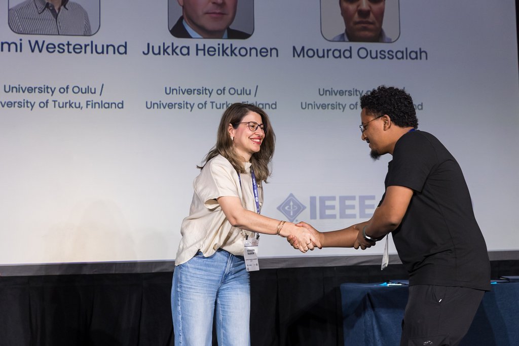 Congratulatory handshake on stage at the award ceremony